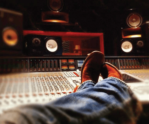 Image of music studio mixing board with NS0-10 in the background