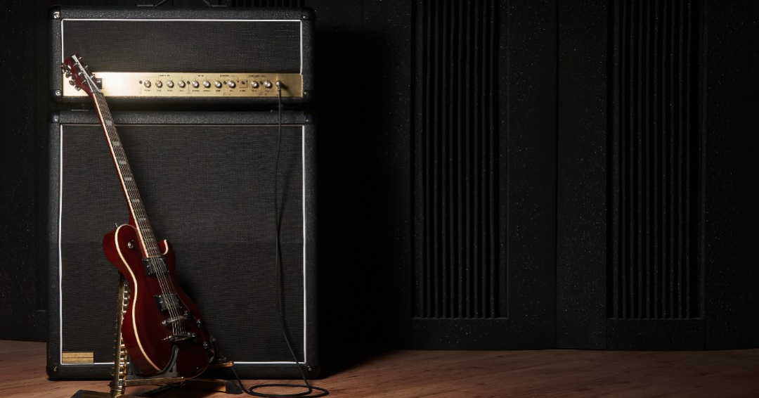 A guitar speaker connected to an amplifier.