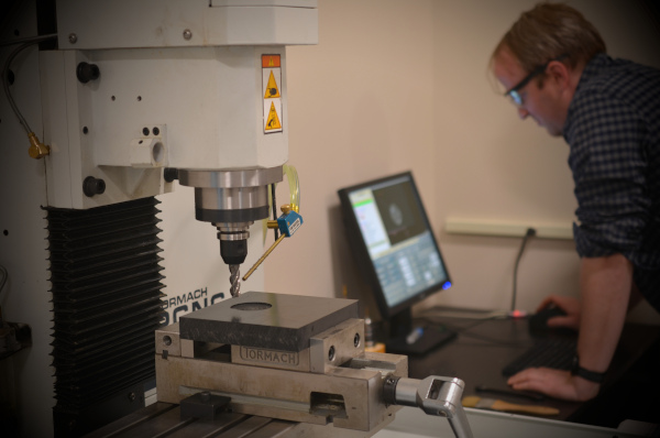 A CNC prototyping mill in use in MISCO's design labs.