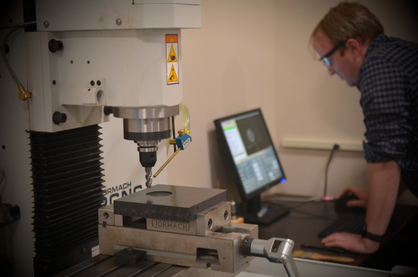 An engineer using a CNC mill.