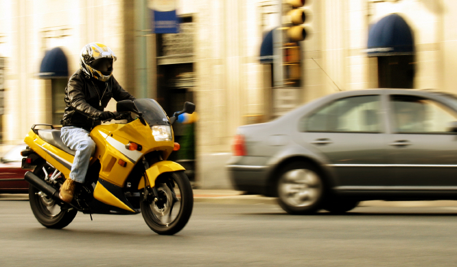 A motorcycle riding through the city.